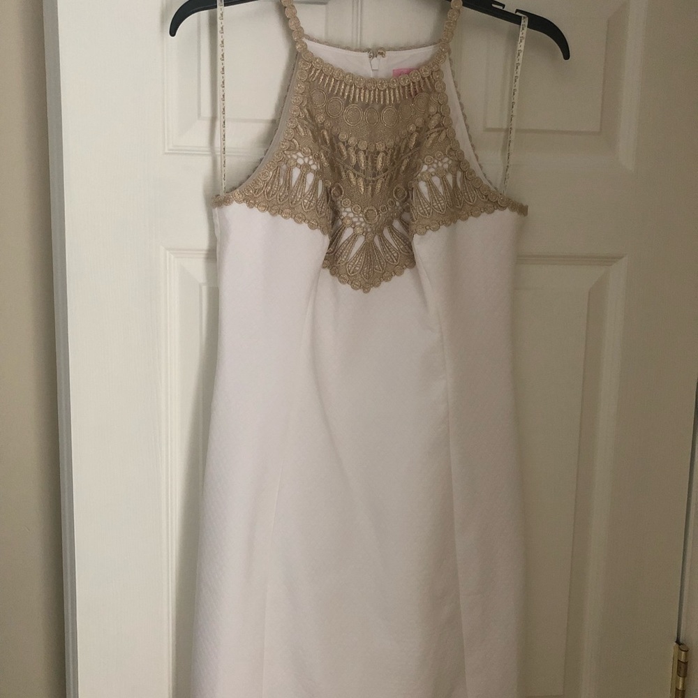 White Lilly Pulitzer dress with gold accents.
